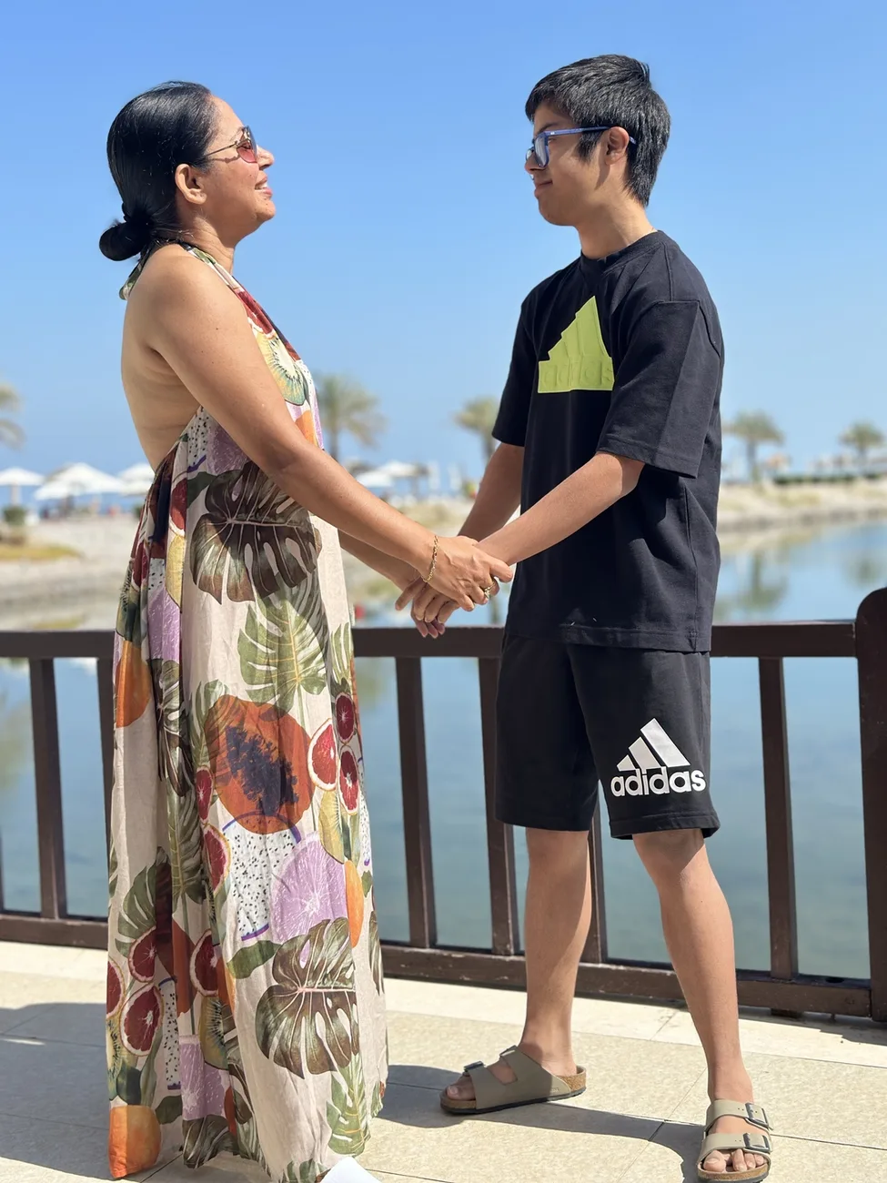 Suchi and Shantanu hand in hand by the water