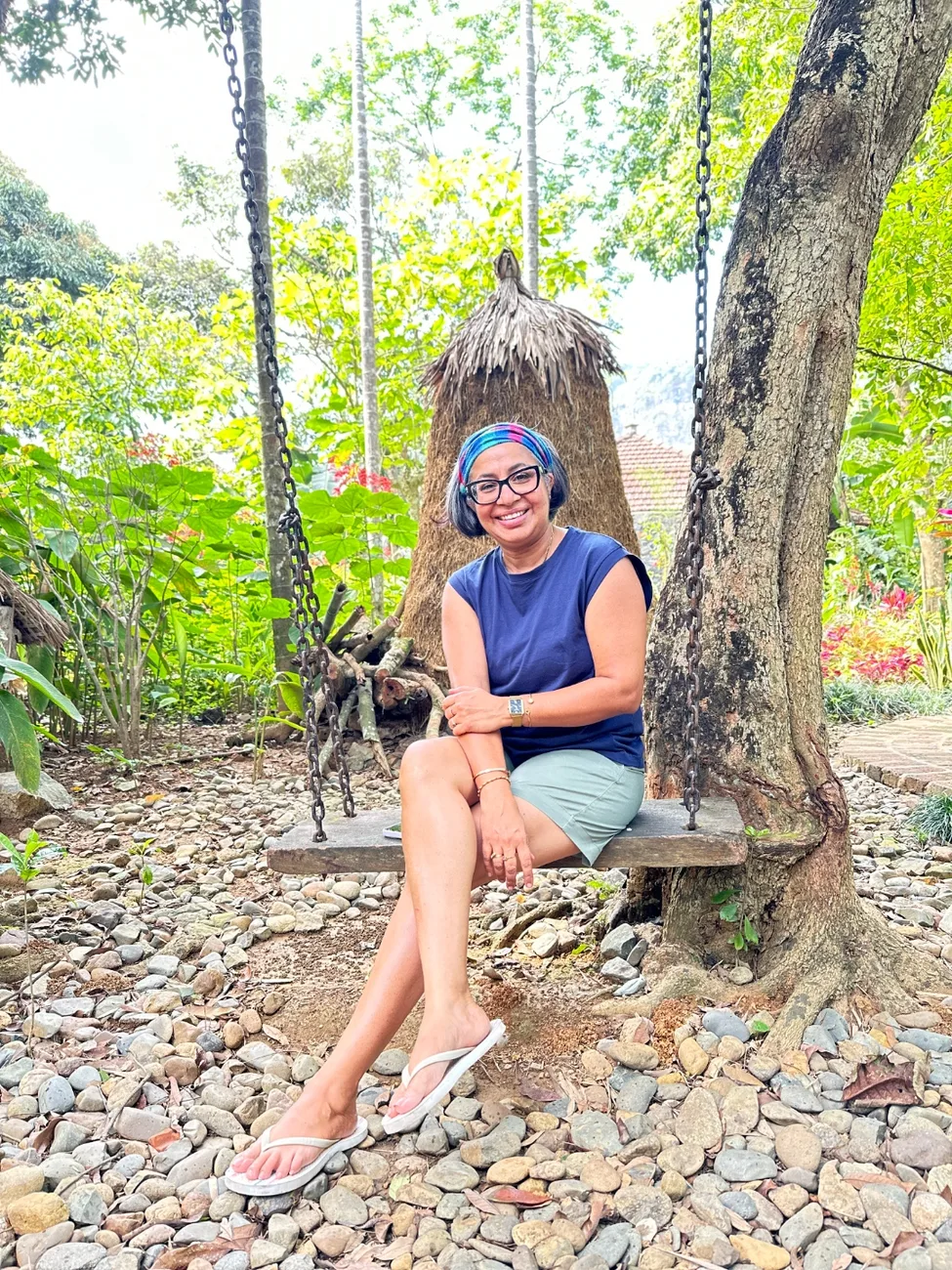 Suchi on a swing under the trees