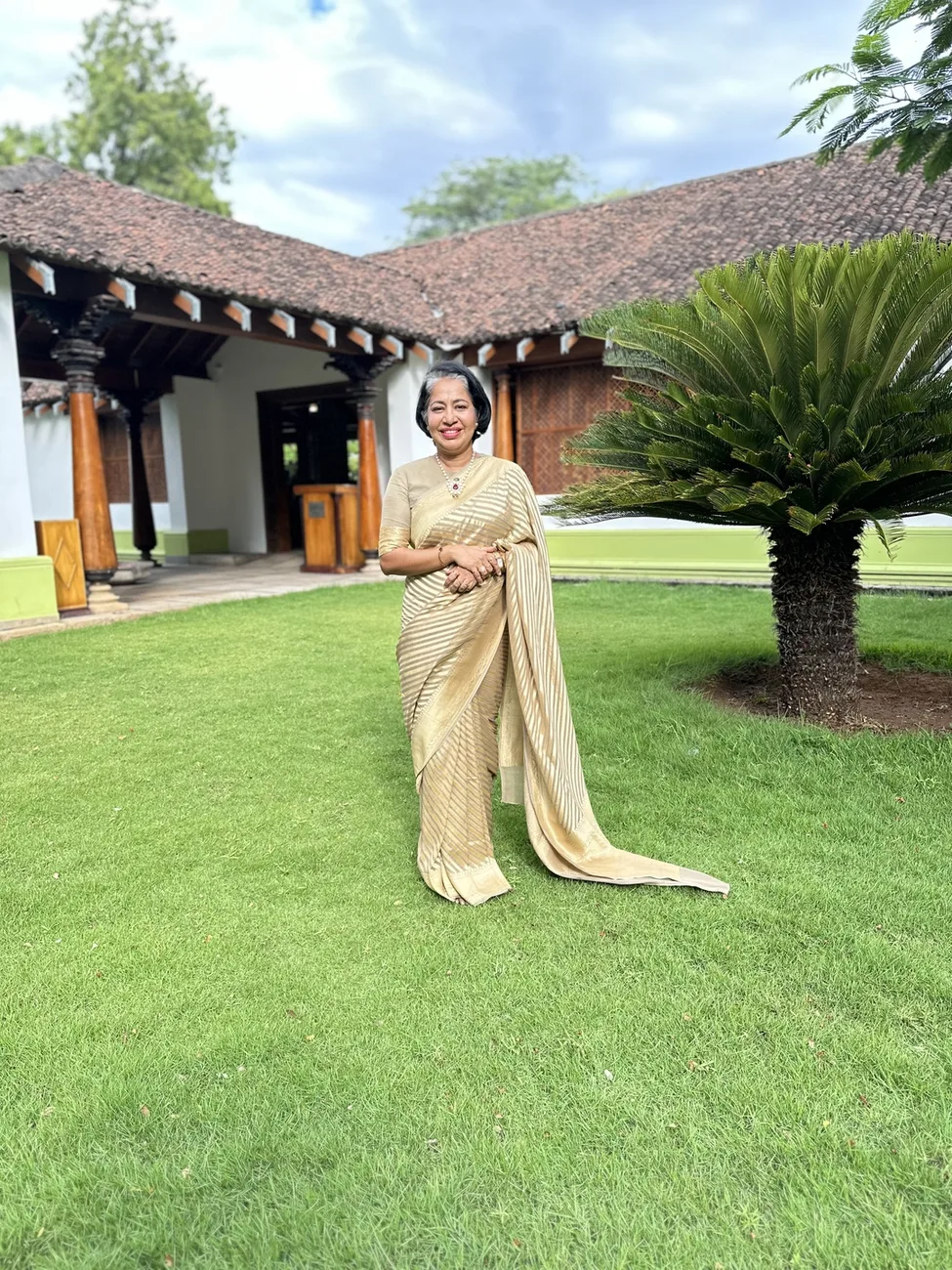 Suchi on the lawn in a saree